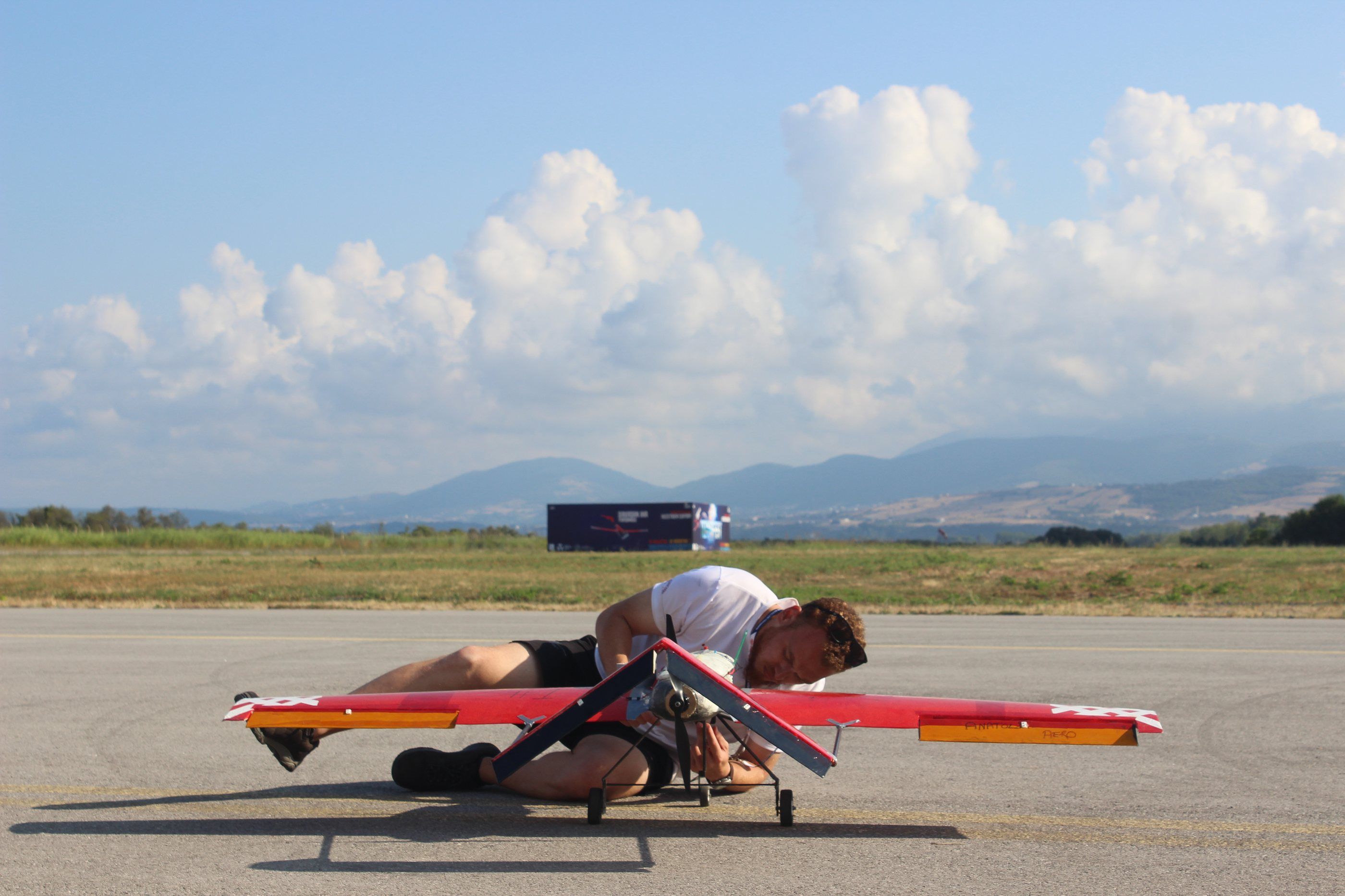Final pre-flight checks on the runway at TEKNOFEST 2022, mountains and clouds behind